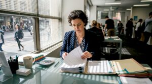 Loan officer reviewing mortgage paperwork at desk