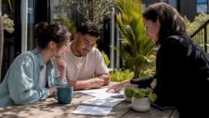 Couple reviewing NZ property offers with adviser